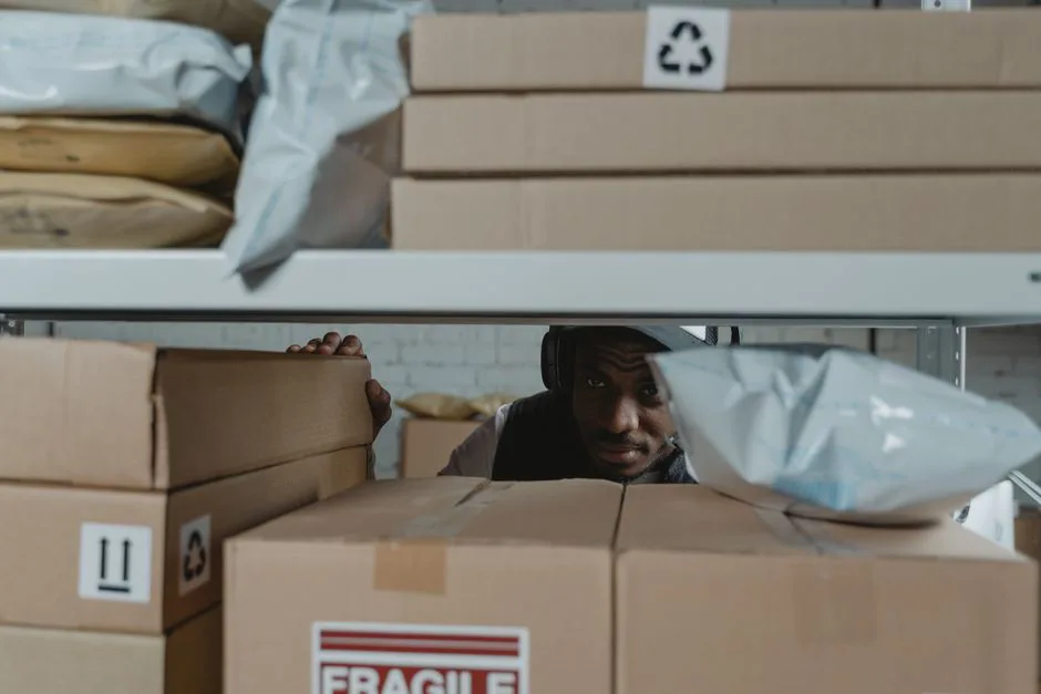 Warehouse worker inspecting a returned package in a Mexico fulfillment center